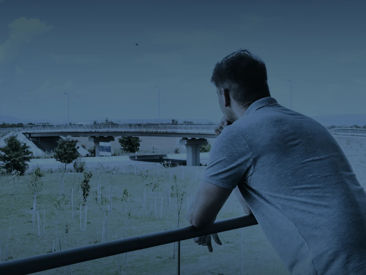 Tudor Costin leaning on a railing, looking into the distance